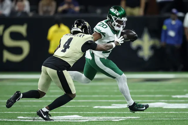 Kool-Aid McKinstry #4 of the New Orleans Saints attempts to tackle Breece Hall #20 of the New York Jets during the second quarter at Caesars Superdome
