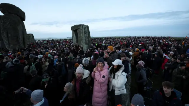 Revellers attend winter solstice celebrations during sunrise at Stonehenge