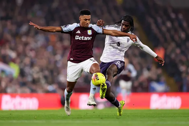 Ollie Watkins of Aston Villa battles for possession with Ayden Heaven of Manchester United during the Premier League match between Aston Villa and Manchester United at Villa Park on December 21, 2025 in Birmingham, England.