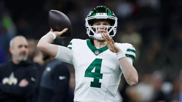 Brady Cook throws the football during warm-ups