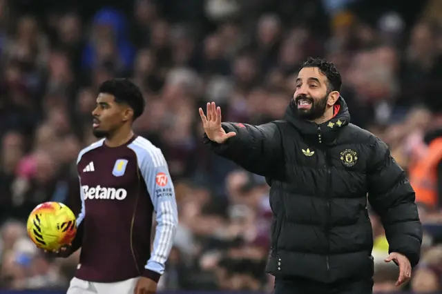 Manchester United's Portuguese head coach Ruben Amorim (R) gestures from the touchline