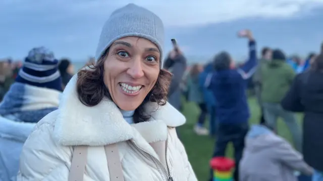 Golnar Pooya in a crowd at Stonehenge