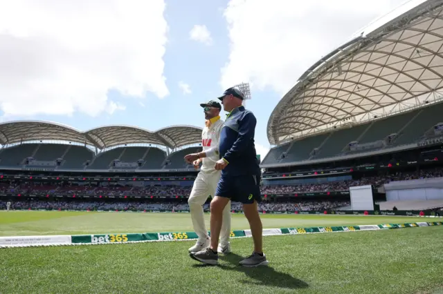 Australia's Nathan Lyon (left) walks off the ground after picking up an injury on day five of the third NRMA Insurance Ashes Series 2025 test at the Adelaide Oval, Australia