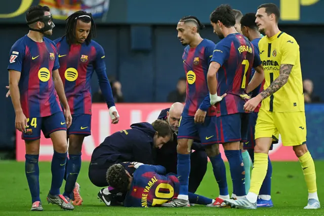Barcelona's Spanish forward #10 Lamine Yamal receives medical attention after resulting injured during the Spanish league football match between Villarreal CF and FC Barcelona at La Ceramica Stadium in Vila-real on December 21, 2025.
