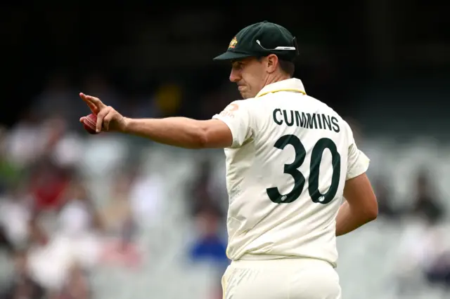 Pat Cummins directs his fielders