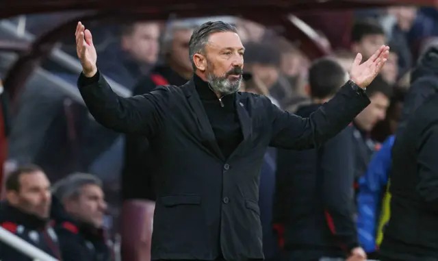 Derek McInnes holds his arms outstretched