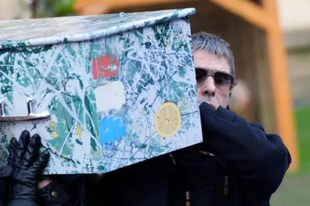 Liam Gallagher carries the coffin from the funeral service of former Stone Roses and Primal Scream bass player Gary Mounfield, who was known as Mani, at Manchester Cathedral, following his death at the age of 63.