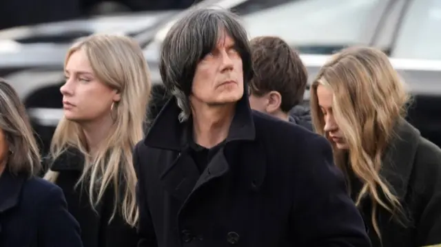 A man with a black coat on