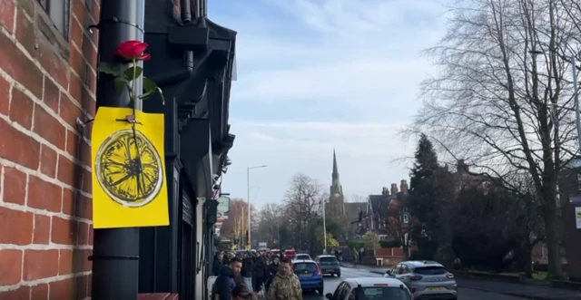 The Stone Roses logo and a rose tied to a lampost