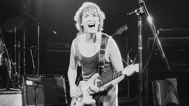Rea performing on stage, circa 1980