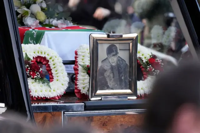 A picture Mani in the hearse following the funeral service of former Stone Roses and Primal Scream bass player Gary Mounfield, who was known as Mani, at Manchester Cathedral, following his death at the age of 63.