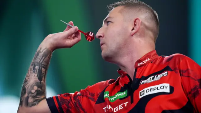 Nathan Aspinall throws a dart