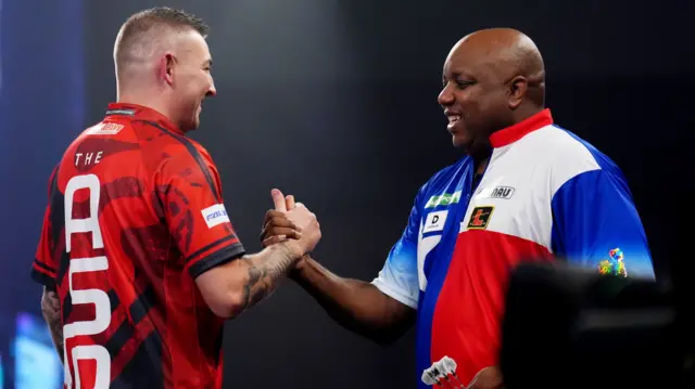 Nathan Aspinall shakes hands with Leonard Gates