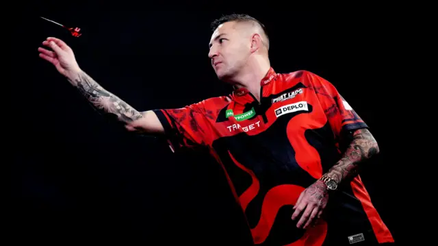 Nathan Aspinall throws a dart