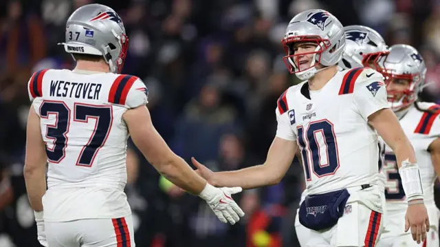 Jack Westover congratulates New England Patriots team-mate Drake Maye during their win over the Baltimore Ravens
