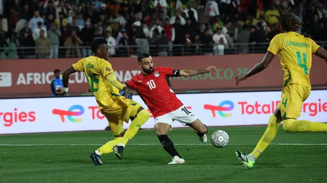 Football player Mo Salah scoring a goal for Egypt at AFCON 2025
