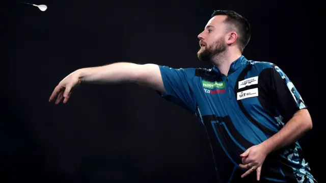 Connor Scutt throws a dart