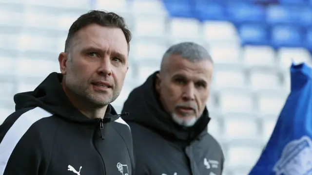 Derby boss John Eustance looks out at the pitch before kick-off