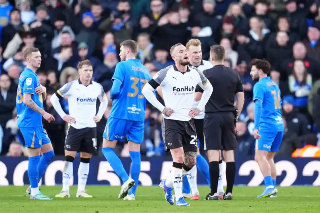 Derby's Joe Ward walks off the pitch after being sent off at Birmingham