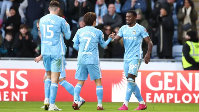 Coventry goalscorer Ephron Mason-Clark is congratulated by his team-mates
