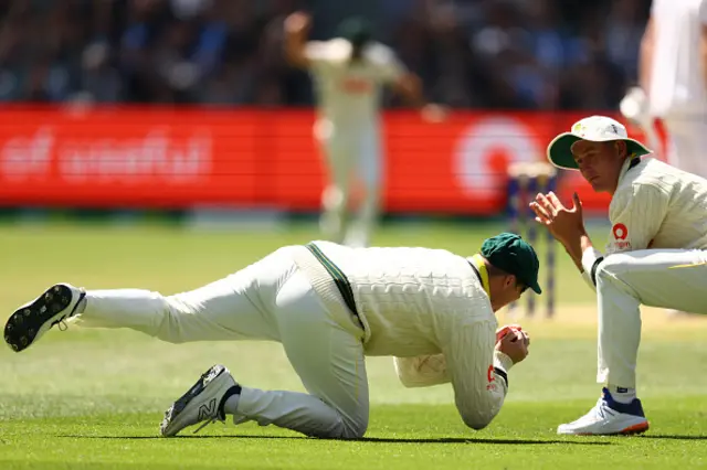 Steve Smith of Australia takes a catch to dismiss Zac Crawley