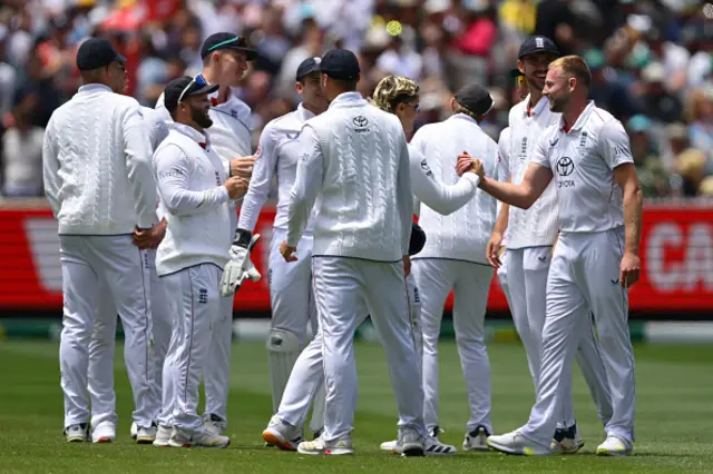 Gus Atkinson of England celebrates with teammates