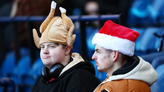 A Bristol City fan wears a turkey hat during their game at West Brom