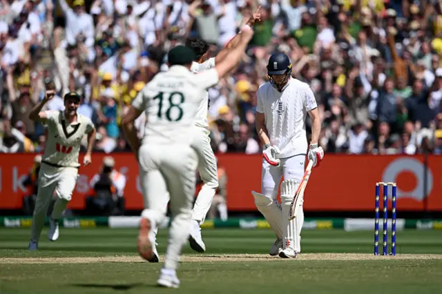 Zak Crawley of England leaves the field after being dismissed by Mitchell Starc