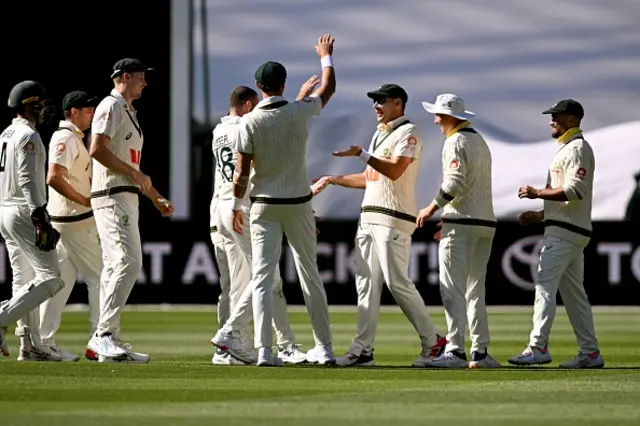 Australia's Scott Boland (3/R) is congratulated by teammates after taking a catch