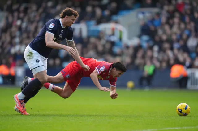 Millwall's Jake Cooper trips Marcelino Nunez of Ipswich Town
