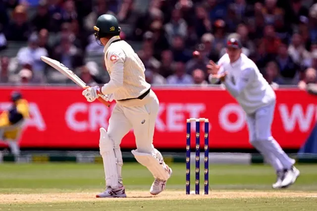 Australian Alex Carey (L) looks back to see England's Zak Crawley (R) take a catch
