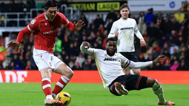 Kieffer Moore scores for Wrexham just before Sheff Utd defender Japhet Tanganga can make a block