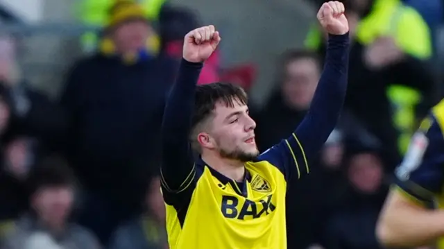 Oxford goalscorer Tyler Goodrhum raises both arms in the air following his goal