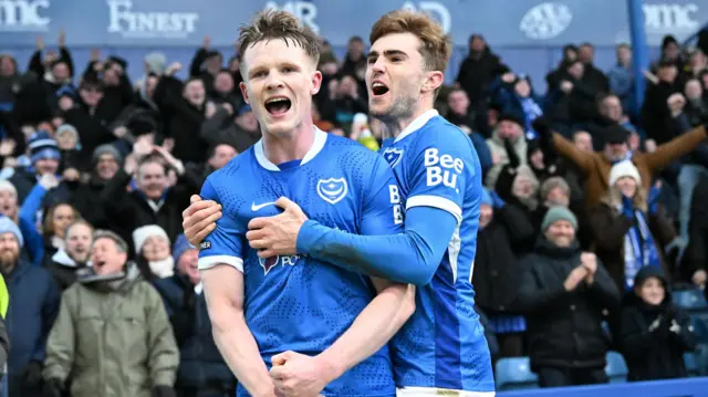 Portsmouth goalscorer Terry Devlin celebrates in front of the home fans