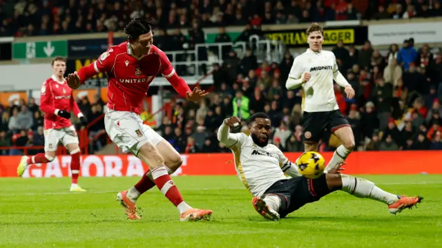 Kieffer Moore finishes as Sheffield United defender Japhet Tanganga slides in