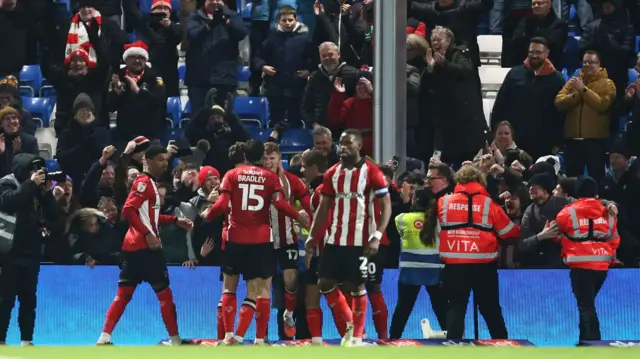 Lincoln celebrate with their fans after beating Stockport