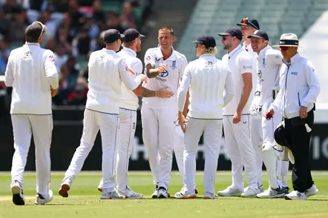 Brydon Carse of England celebrates with teammates the wicket of Cameron Green