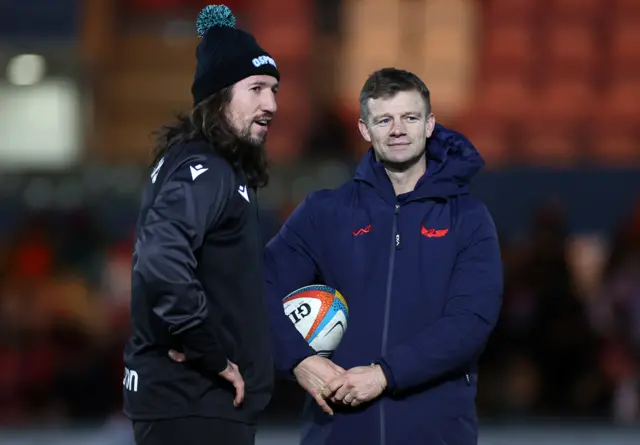 Scarlets head coach Dwayne Peel has a pre-match chat with Ospreys defence coach Justin Tipuric