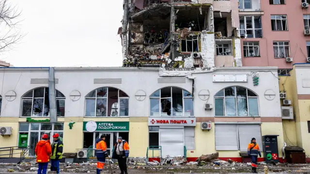 A shopfront with a partially destroyed building above