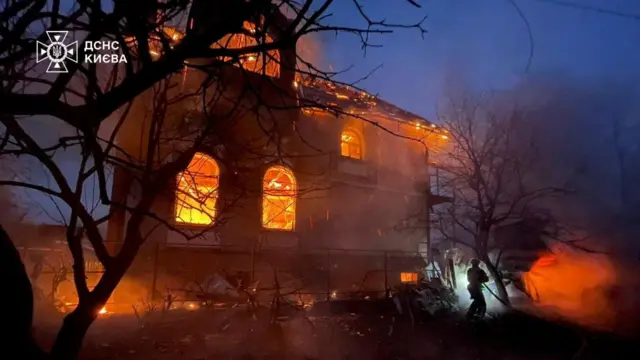 A house on fire in Kyiv. Flames burn in the windows
