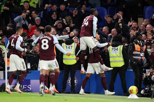 Ollie Watkins of Aston Villa celebrates scoring his team's second goal with teammate Amadou Onana during the Premier League match between Chelsea and Aston Villa at Stamford Bridge on December 27, 2025 in London, England.