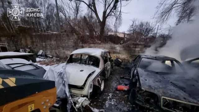 A smouldering car that was hit by Russian missiles