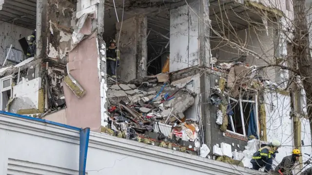 Rescuers search through rubble