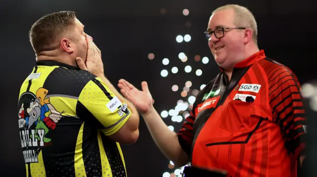 James Hurrell shakes hands with Stephen Bunting