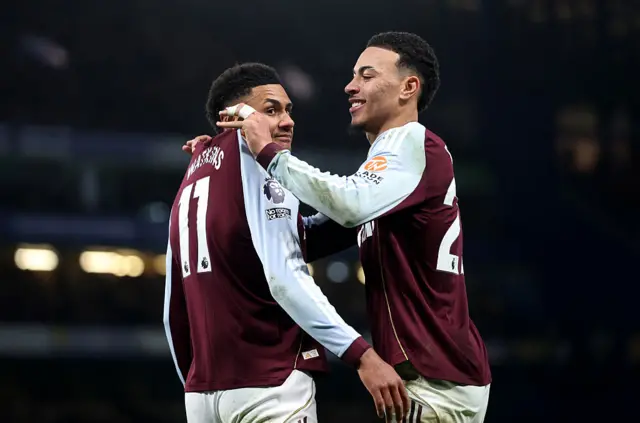 Ollie Watkins of Aston Villa celebrates scoring his team's second goal with teammate Morgan Rogers during the Premier League match between Chelsea and Aston Villa at Stamford Bridge on December 27, 2025 in London, England.