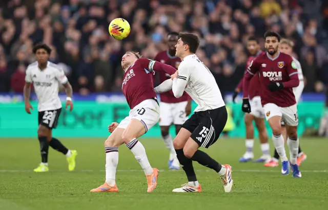 Jarrod Bowen of West Ham United battles for possession with Jorge Cuenca of Fulham