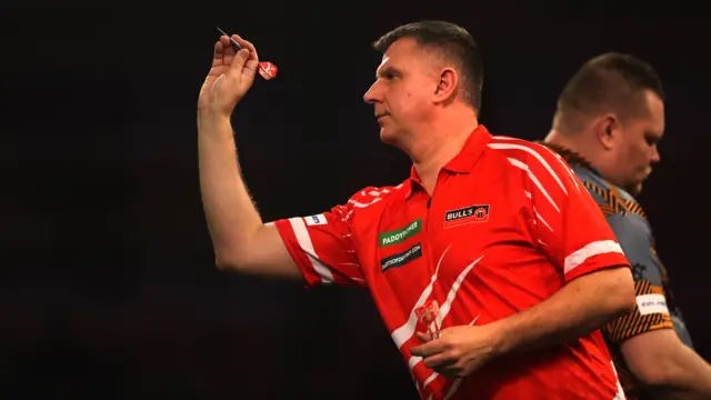 Krzysztof Ratajski throws a dart