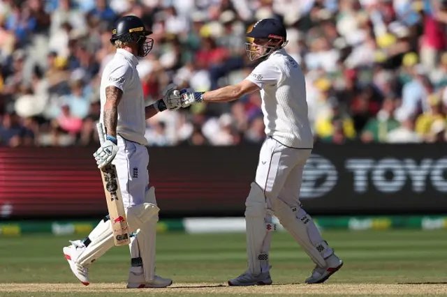 England's Ben Stokes (L) and Harry Brook touch gloves