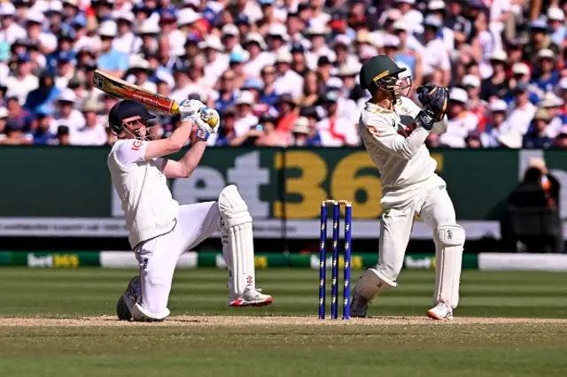 England batsman Harry Brook (L) plays a shot as Australia's Alex Carey looks on