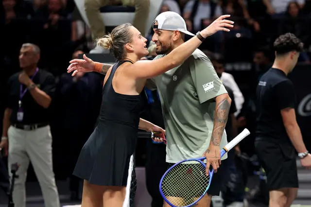 Belarus' Aryna Sabalenka and Australia's Nick Kyrgios embrace at the net